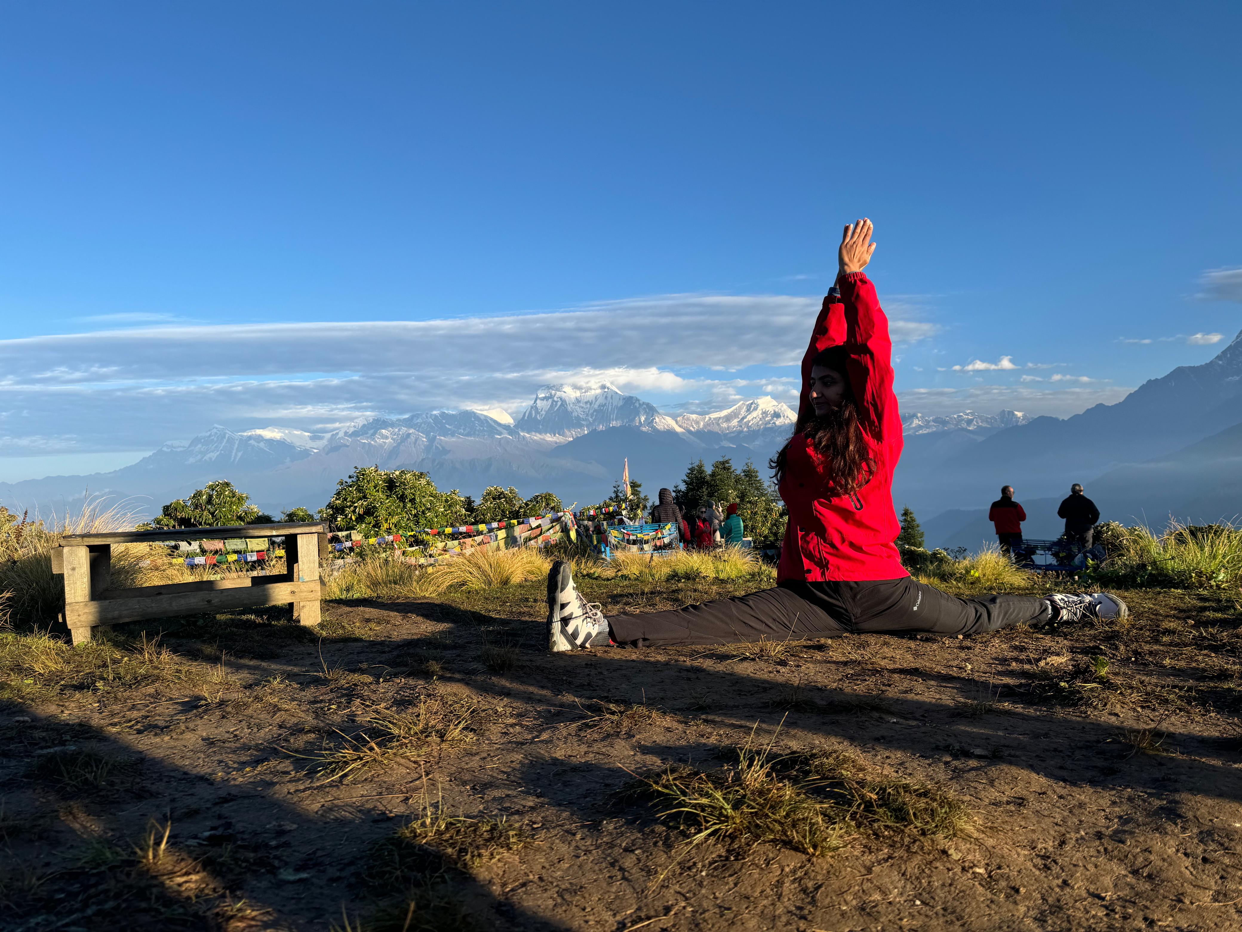 Yoga split pose with Himalayan Mountains in background